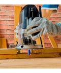 Get Ready For A Flawless Finish With This 4 Pcs Flush Trim Router Bit Set in use on wood, featuring visible router bit and gloves.