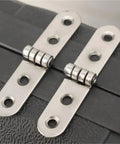 Two metal 40 Pieces Rounded Corner Folding Hinges for Cabinets Tables and Furniture 180 Degree Universal Folding Hinge installed on black surface.