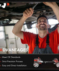 Drive shaft flex joint coupler with bolts; mechanic in a red shirt works under a car.