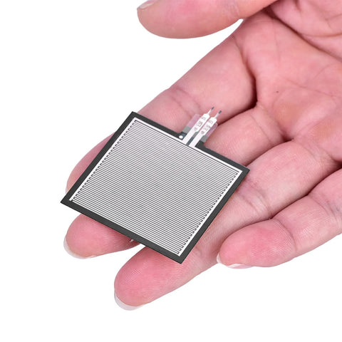 Front view: S40 ST thin Kraftsensor pressure sensor pad; rectangular gray film with parallel stripes, held in hand.