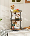 3 Tier Lazy Susan Spice Rack Rotating Turntable Organizer For Cabinet, Countertop And Pantry Spins Smooth Like A Boss With A 360 Degree Spin Rustic Brown And Black Finish SR23BR 10.2 X 10.2 X 18 Inches on a table with items.