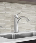 Modern kitchen with Dope Chrome Kitchen Soap Dispenser, Deck Mounted With Above-Sink Refillable 18 Oz Bottle next to sleek faucet.