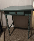 A wooden table with a drawer, featuring a Vintage Style Brass Ring Pulls For Cabinets And Drawers.