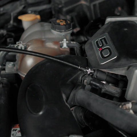 Flexible Socket Extension Set for 1/4 and 3/8 Inch Drive being used on car engine to loosen tight bolts in hard to reach spots.