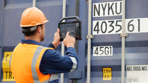 Field technician using Built Like A Tank 10.1 Inch Rugged Tablet With Intel Core I7 And VPro Tech for logistics work.