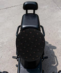 Kickass Black Plush Motorcycle Seat Cover With Dope QuickGrip Straps For Dirt Bikes And Mopeds Providing Cozy Winter Warmth on a motorcycle.