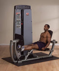 Man using All In One Leg And Calf Press Machine With 210 Lb Weight Stack for home gym leg press exercises indoors.