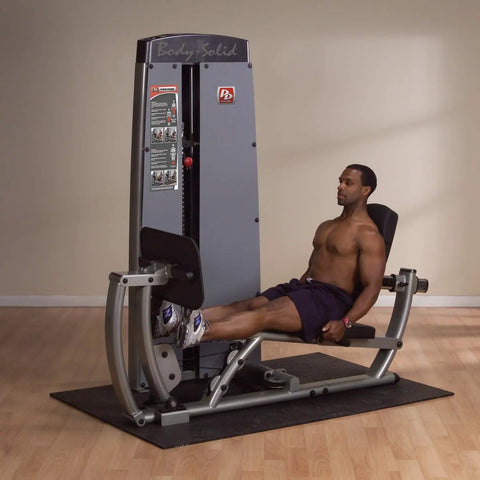 Man using All In One Leg And Calf Press Machine With 210 Lb Weight Stack for home gym leg press exercises indoors.