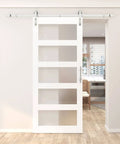 36 Inch By 84 Inch 5 Panel Glass Barn Door With Six Point Six Feet Brushed Nickel Sliding Hardware And Handle Frosted Glass Solid Wood Core With Waterproof PVC Surface Pre Drilled For Easy Assembly White shown installed in a room.