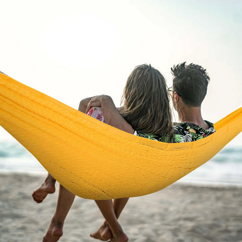 Couple relaxing on Extra Large Mayan Hammock With Soft Rope Comfort on the beach, yellow outdoor swing bed, dual person view