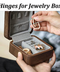 Hands holding open jewelry box with hidden hinges, showcasing brass barrel hinge set for a clean seamless look in DIY projects.