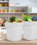 10 Pack 1.4 Quart White Plastic Storage Buckets with Airtight Lids and Handles on kitchen counter with vegetables