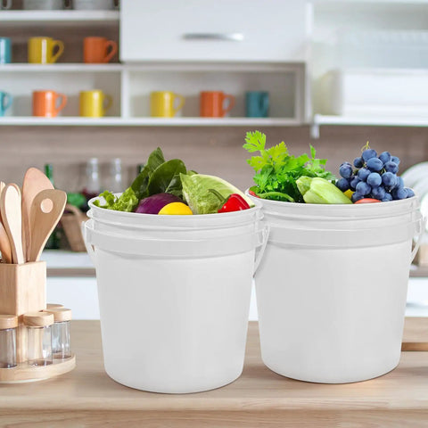 10 Pack 1.4 Quart White Plastic Storage Buckets with Airtight Lids and Handles on kitchen counter with vegetables