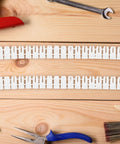 Heavy Duty Drywall Anchors Kit 300 Pcs Plastic Wall Expansion Anchors on wood surface with tools.