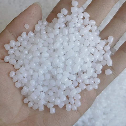 Hand holding 2 lb plastic pellets rock tumbler media protect delicate stones non toxic non static reusable filler in reclosable bags