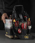 Person holding 25 Pocket Electrical And Maintenance Tool Carrier With 7 Inch By 5 And A Half Inch Multi Compartment Tray Box Style Pouch