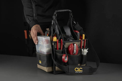 Person holding 25 Pocket Electrical And Maintenance Tool Carrier With 7 Inch By 5 And A Half Inch Multi Compartment Tray Box Style Pouch