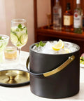 3.2 Liter Double Wall Stainless Steel Ice Bucket With Silicone Lid Scoop And Strainer Insulated Ice Bin For Parties And Cocktail Bars Keeps Ice Frozen Longer Sleek Black Gift Idea on a counter with drinks