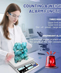 Scientist using heavy duty counting scale for small parts 30kg 66lb capacity, 1g precision, with weight alarm in laboratory.