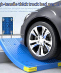 Heavy Duty Platform Hand Truck Featuring 360 Degree Swivel Wheels And Adjustable Safety Rail Built As The Rock Solid Workhorse For Smooth Warehouse Cargo Hauling on blue ramp under car tire.