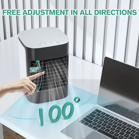 3-In-1 Mini Evaporative Air Conditioner Fan With USB Charging near laptop on desk, showcasing 100-degree swing adjustment.