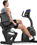 Man using Recumbent Exercise Bike With 32 Level Magnetic Resistance For Home Gym Use, Quiet Low Impact Cardio, 400 Lb Weight Capacity