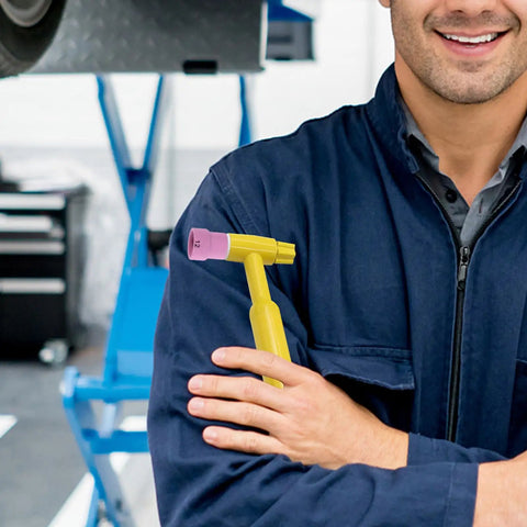 Rock Solid Pink Tig Welding Cups That Make Cleaning A Breeze, Sturdy Ceramic Nozzles To Slash Defects And Downtime While You Crush Your Projects held by a smiling man in a blue work jacket.