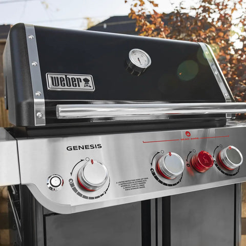 Close-up of Genesis E 325 Liquid Propane Gas Grill For Outdoor Cooking With Three Burners Black Porcelain Enameled Cast Iron Grates