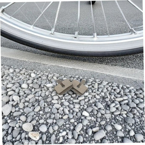 2 Pairs Bike Disc Brake Pads For Hydraulic And Mechanical Disc Brakes Replacement Pads For Mountain Bikes And Electric Scooters Quiet High Braking Power Wide Compatibility And Smooth Stopping On Rough Trails placed near bicycle wheel