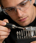 Person using Pro Grade Diamond Coated Rotary Burr Set with 50-piece grinding bits on a tool, 1.6 mm shank, for stone carving