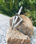 Fixed Blade Hunting Broadhead 100 Grain 420 Stainless Steel Three Razor Sharp Blades Vented Design on rocks.