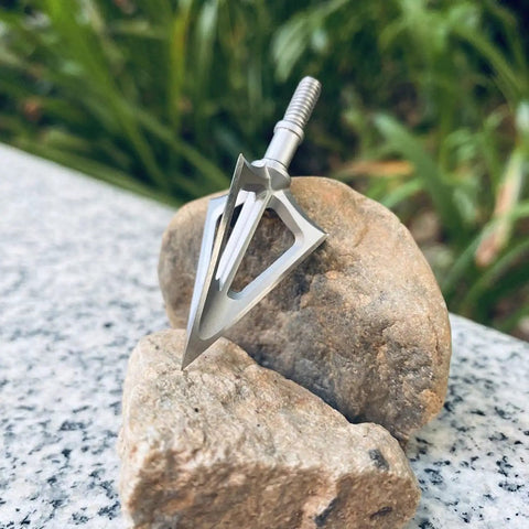 Fixed Blade Hunting Broadhead 100 Grain 420 Stainless Steel Three Razor Sharp Blades Vented Design on rocks.