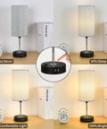 Three Way Touch Dimmable Bedside Lamp with USB Ports and One Outlet Gray Shade Bulb Included showing dimming settings.