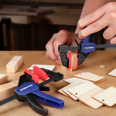 Close-up of Six Inch Mini Bar Clamps Set Two Pack For Woodworking, One Handed Clamp And Spreader, holding wood pieces, on a table
