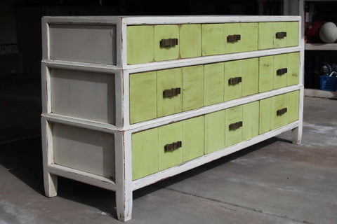 Top Tier Paste Wax For Wood And Cabinet Surfaces With Real Beeswax Blend on a vintage style cabinet with green and gray drawers.