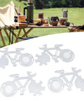 Four stainless steel Bike Shaped 14 In 1 Pocket Multitool Cards with camping setup in background