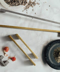 Six Pack Light Brushed Brass Cabinet Pulls In Zinc Alloy, 11 1/3 Inch Or 12 3/5 Inch Hole Centers, shown on marble surface.