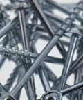 Close-up of zinc-coated self-tapping wood pocket hole screws with coarse thread and Torx drive for indoor use.