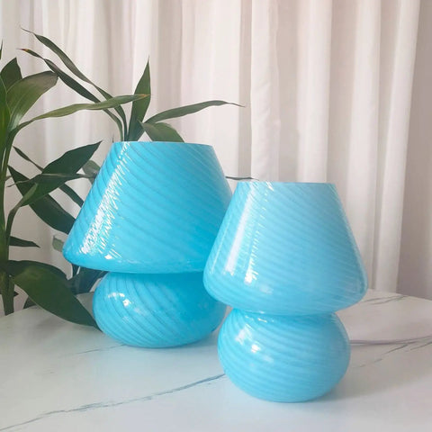 Pair of blue glass lamps with swirl pattern on table, potted plant in background, Swirl Mushroom Glass Lamp In Striped Pink, Hand Blown Translucent Murano Style Table Bedside Light, Italian Modern Decor For Living Room, Dining, Study, Or Baby Nursery, Cozy Home Vibe, Mini Dia 5.1 By 7.1 Inch High