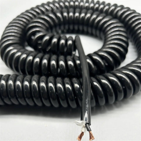 Close-up of Heavy Duty Two Core Coiled Extension Cord With Smooth Retractable Stretch Design for easy indoor and outdoor use.
