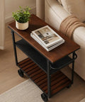 Smooth Rolling Three Tier Bar Cart With Sturdy Handle And Mobile Kitchen Microwave Rolling Stand With Chic Industrial Beverage Serving Design In Rustic Brown Metal And Wood, top view with plant and books.