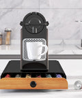 Coffee Pod Drawer Organizer For Nespresso OriginalLine Capsules Holds 60 Pods In 6 Clear Columns Easy Slide Drawer Coffee Storage For Home Office Keeps Flavor Selections Neat And Accessible Black with a coffee machine on top.