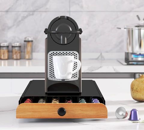 Coffee Pod Drawer Organizer For Nespresso OriginalLine Capsules Holds 60 Pods In 6 Clear Columns Easy Slide Drawer Coffee Storage For Home Office Keeps Flavor Selections Neat And Accessible Black with a coffee machine on top.