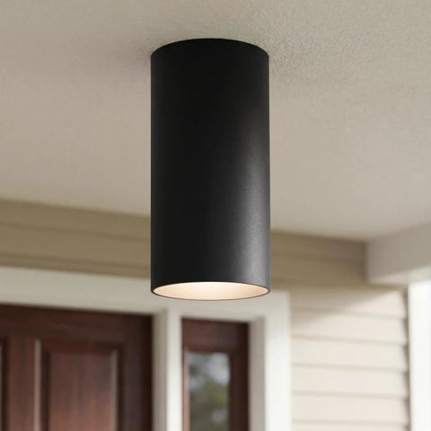 Sleek Six Inch Cylinder Outdoor Ceiling Light, black aluminum, shown mounted on porch ceiling. Modern, minimalist, damp-rated design.