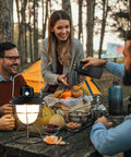 Group enjoying outdoor meal with Legit 64 Oz Insulated Water Bottle Triple Wall Vacuum Stainless Steel used for hydration.