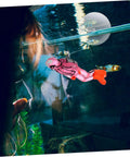 Floating Diver Aquarium Decor For Fish Tanks shown glowing, colorful resin, diver ornament with adjustable dive pose in aquarium.