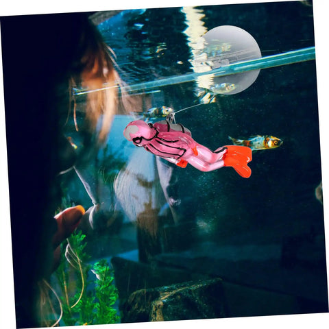 Floating Diver Aquarium Decor For Fish Tanks shown glowing, colorful resin, diver ornament with adjustable dive pose in aquarium.