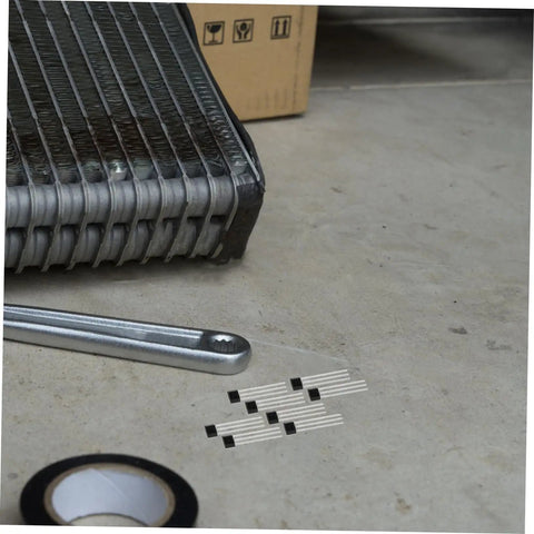 15 Piece Linear Hall Effect Sensor Module Kit For Automotive And Industrial Applications on the floor beside a tool and tape.