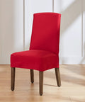 Red dining chair cover in vibrant fabric fitted on a wooden chair, highlighting design and fit.