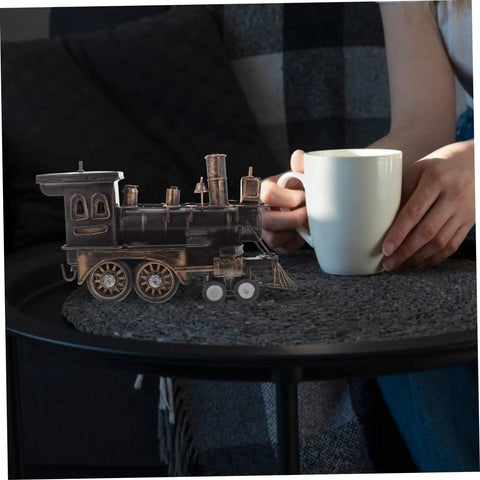Locomotive Model Retro Steam Train Sculpture For Desktop Decoration next to a coffee cup, showcasing vintage style and detail.